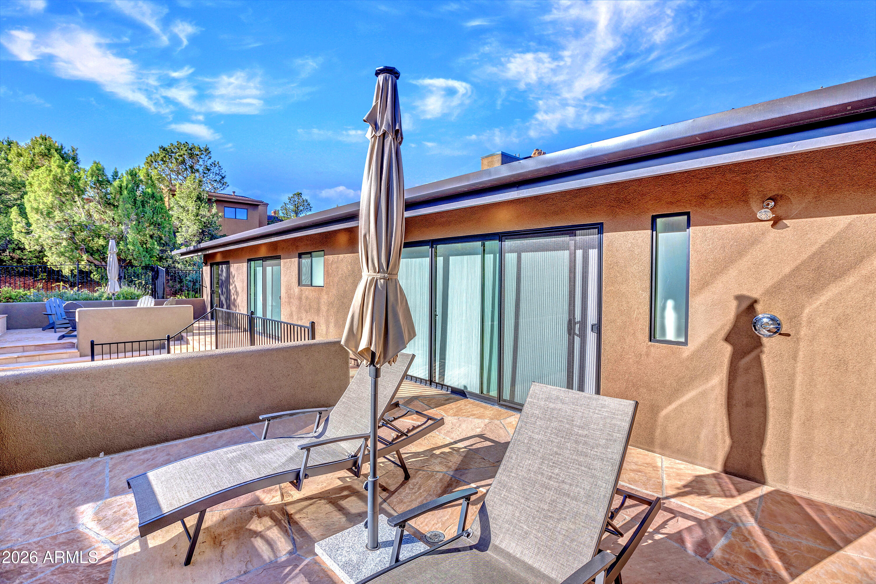 180 Rim Shadows Drive Sedona, AZ 86336 - Photo 50 of 72 a view of a patio with a table chairs and a potted plant