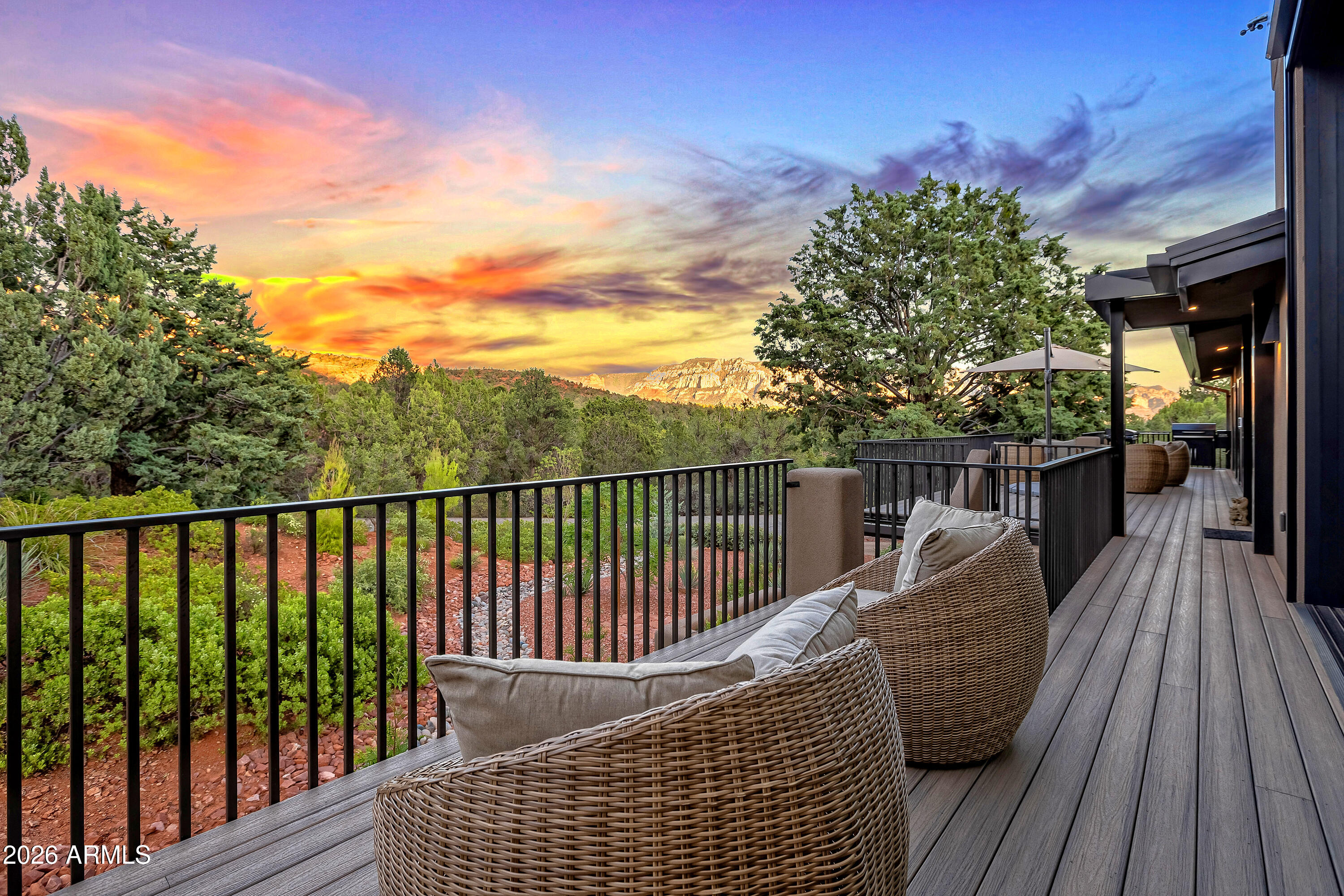 180 Rim Shadows Drive Sedona, AZ 86336 - Photo 53 of 72 a balcony with wooden floor table and chairs