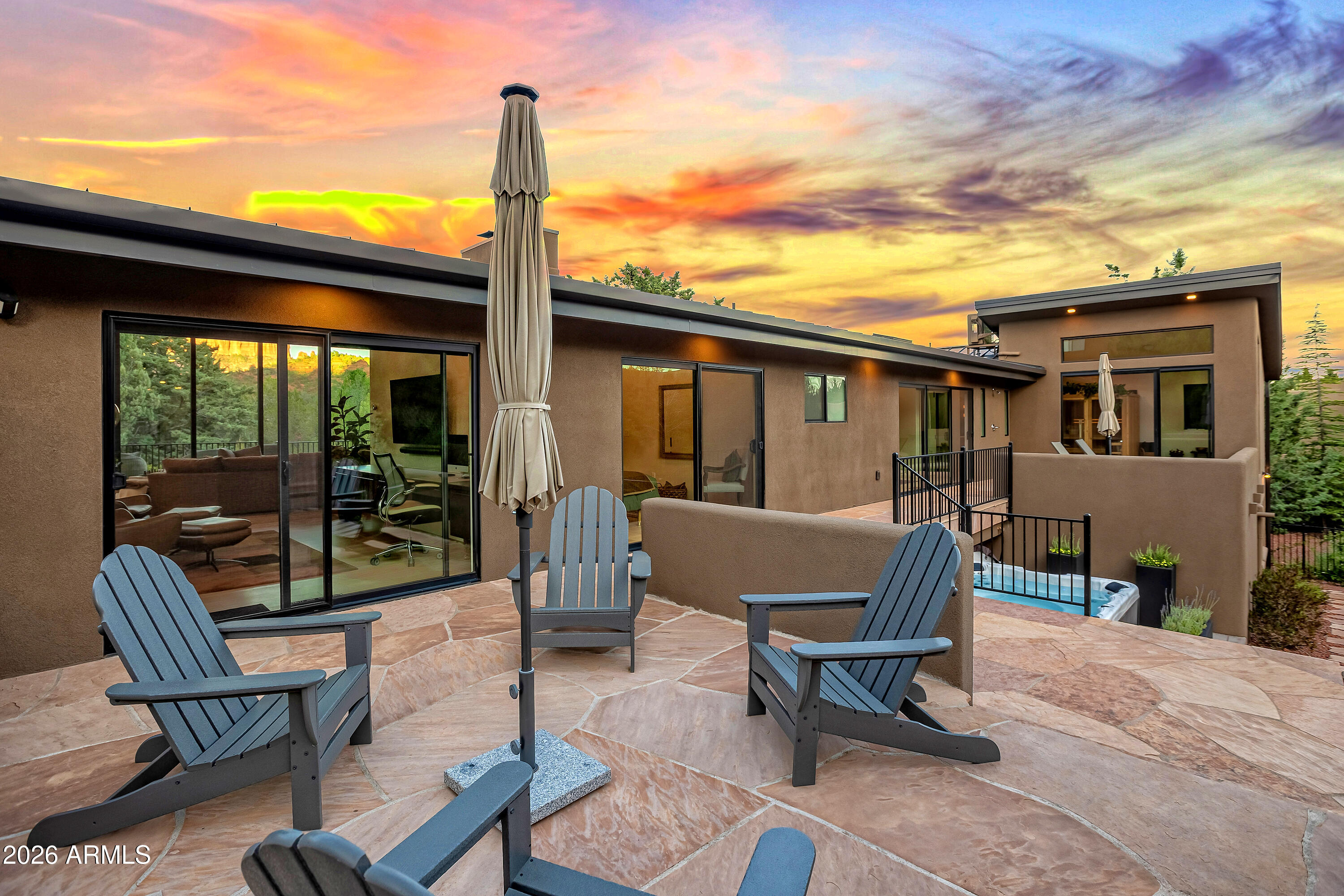 180 Rim Shadows Drive Sedona, AZ 86336 - Photo 55 of 72 a view of a patio with a table chairs and a floor
