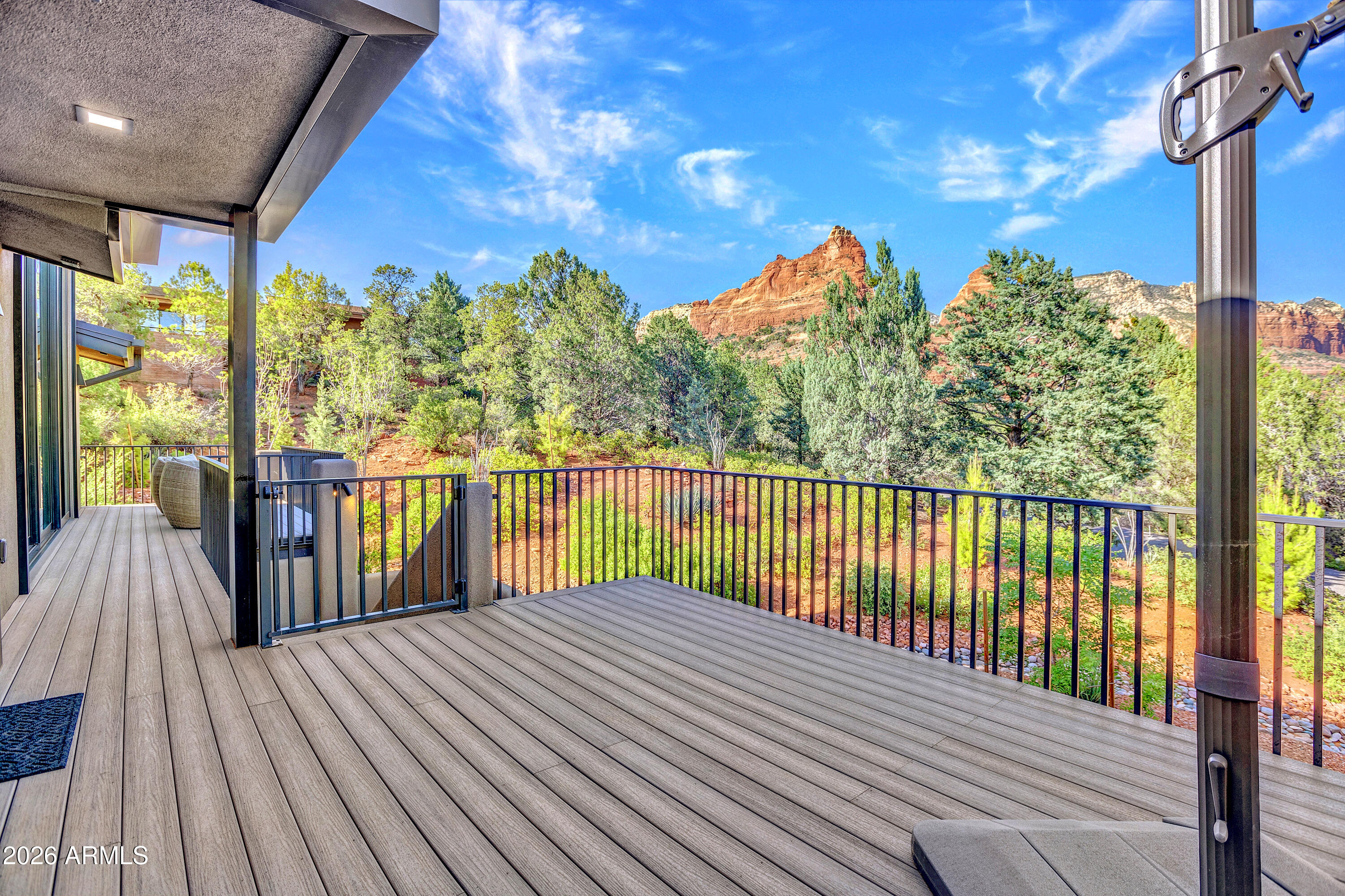 180 Rim Shadows Drive Sedona, AZ 86336 - Photo 62 of 72 a balcony with view of trees in the background