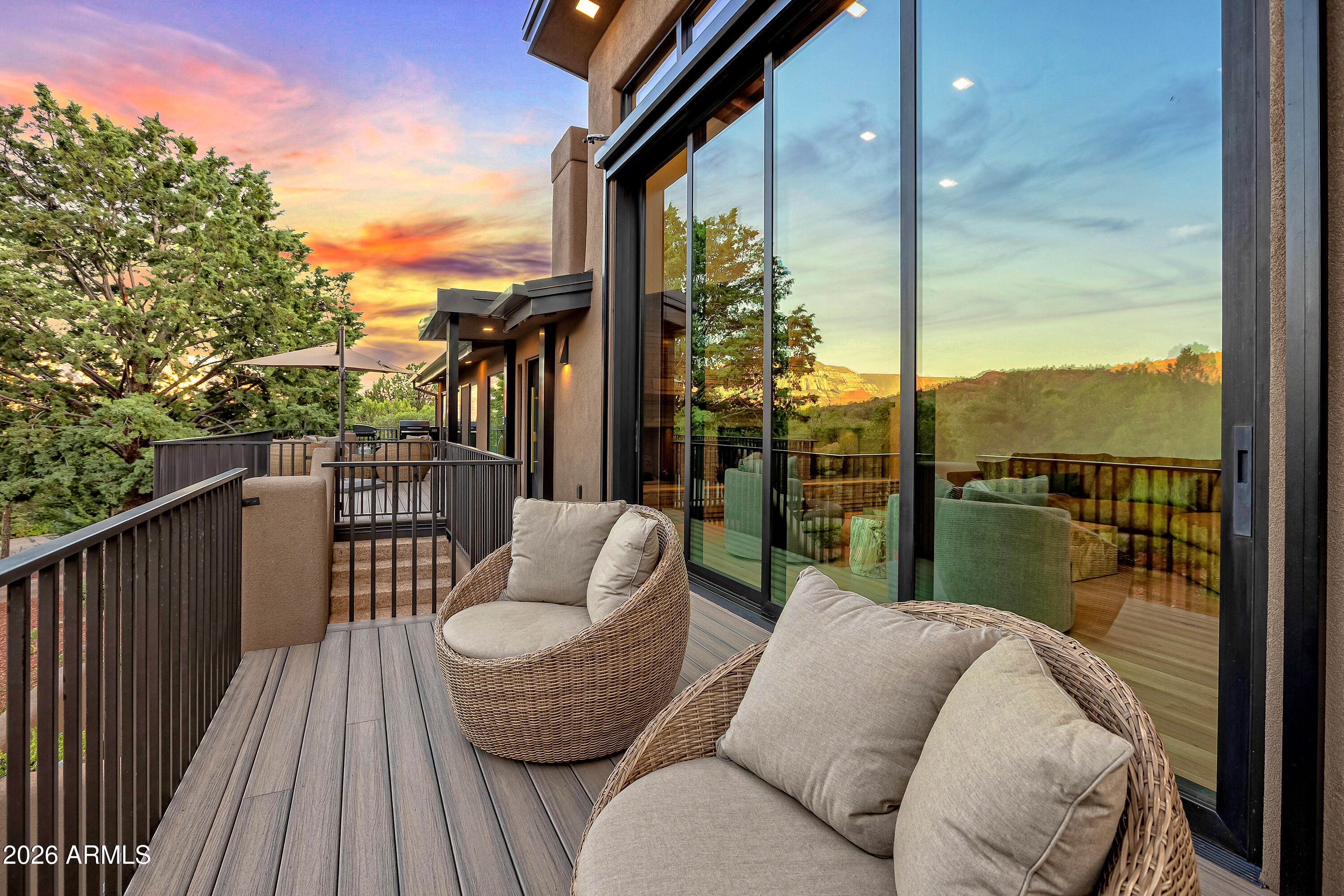 180 Rim Shadows Drive Sedona, AZ 86336 - Photo 65 of 72 a balcony with furniture and a floor to ceiling window