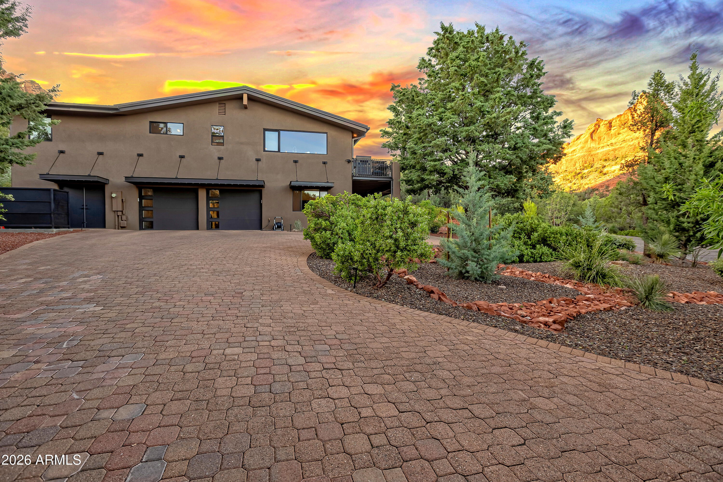 180 Rim Shadows Drive Sedona, AZ 86336 - Photo 66 of 72 a front view of a house with a yard