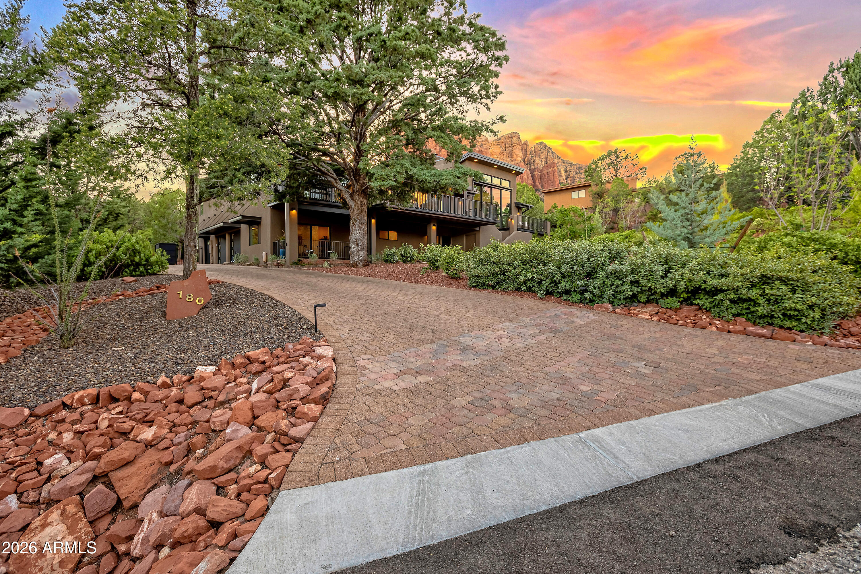 180 Rim Shadows Drive Sedona, AZ 86336 - Photo 69 of 72 a front view of a house with a yard