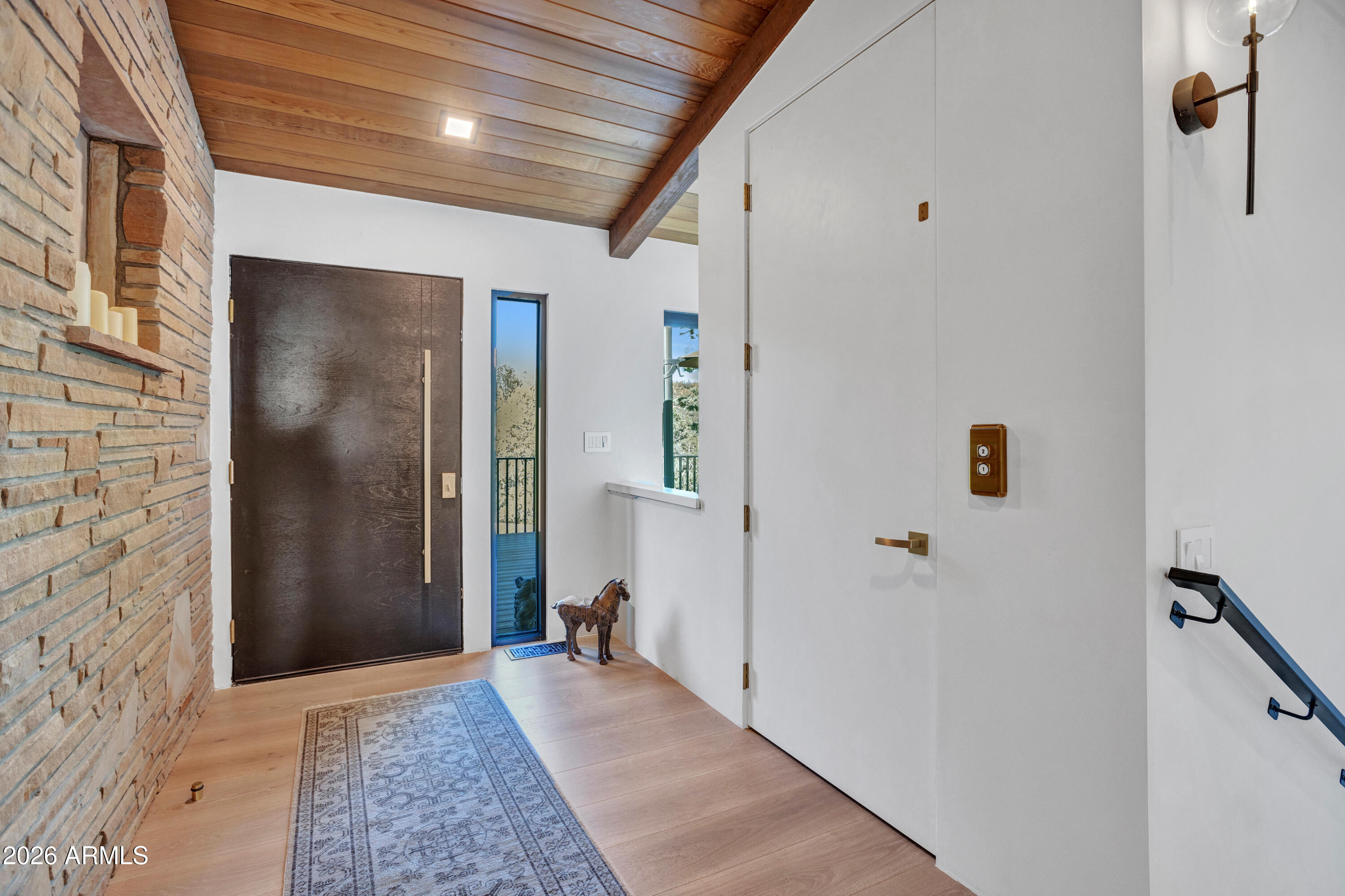 180 Rim Shadows Drive Sedona, AZ 86336 - Photo 10 of 72 a view of a hallway with wooden floor and staircase