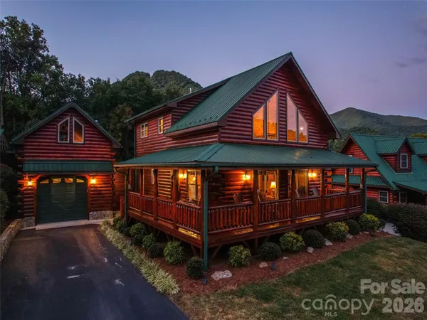 a view of a small house with wooden fence
