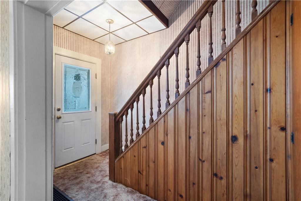 520 Center Street Rochester, PA 15074 - Photo 5 of 24 a view of staircase with lots of frames on wall and wooden floor