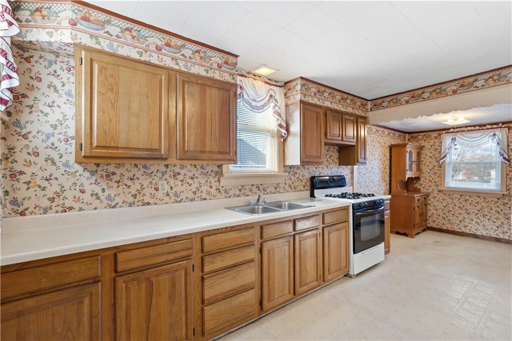 520 Center Street Rochester, PA 15074 - Photo 7 of 24 a kitchen with a sink stove and cabinets