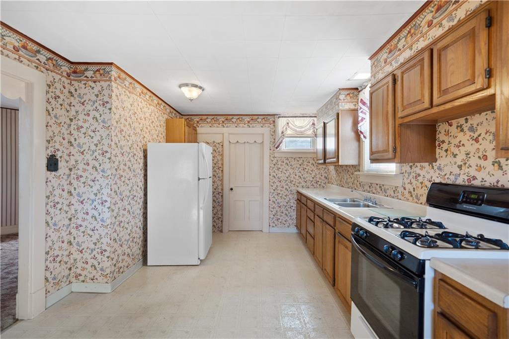 520 Center Street Rochester, PA 15074 - Photo 8 of 24 a kitchen with stainless steel appliances granite countertop a stove and a refrigerator