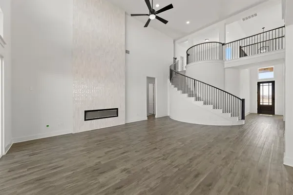 a view of a hallway with wooden floor and staircase