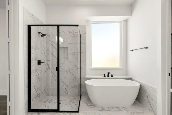 a bathroom with a bathtub and shower