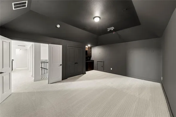 a large white room with windows and cabinet