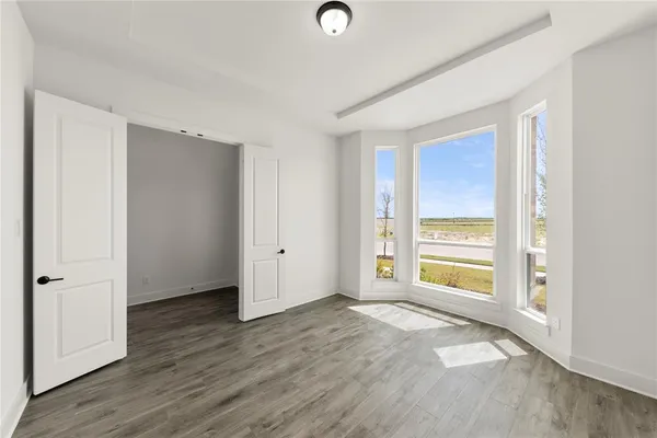 a view of a room with wooden floor