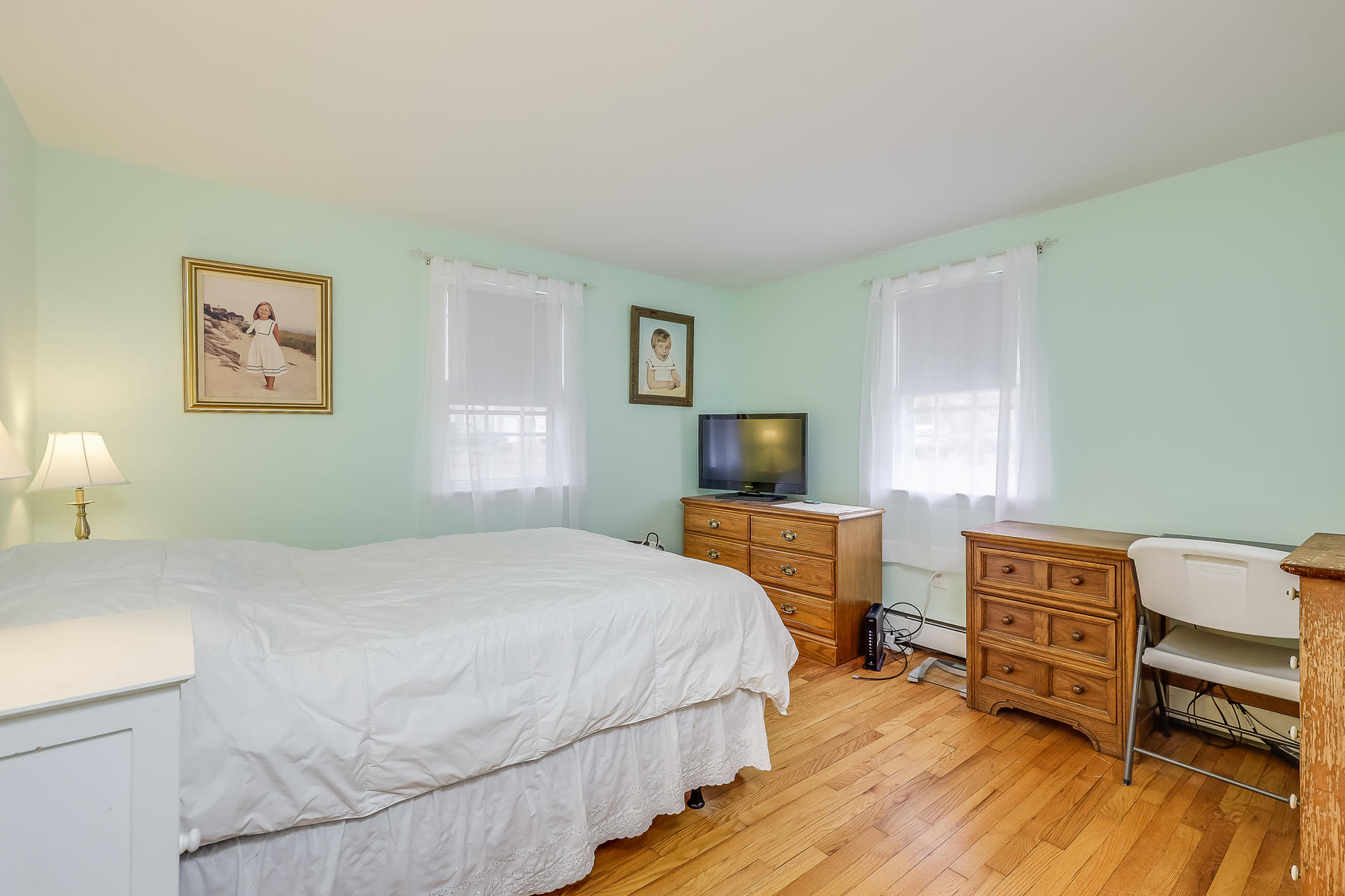 116 Long Road Harwich, MA 02645 - Photo 15 of 32 a bedroom with a bed and a dresser with wooden floor