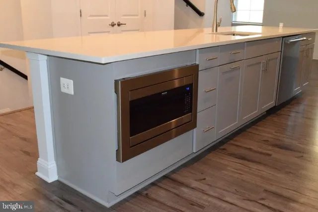 a kitchen with granite countertop white cabinets and white appliances