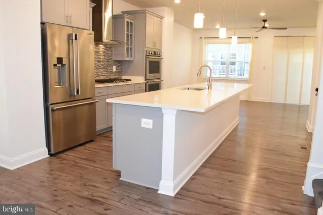 a view of a livingroom with a ceiling fan and window