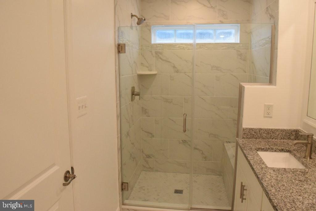 7505 Ledgers Way Hanover, MD 21076 - Photo 32 of 50 a bathroom with a sink and a shower