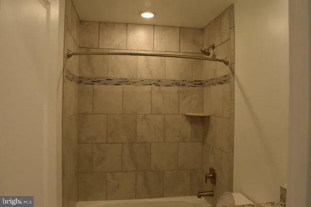 a bathroom with a shower and a bath tub