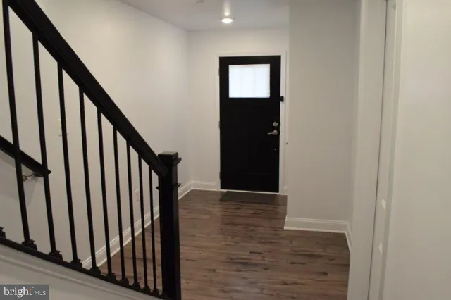 a view of an entryway with wooden floor