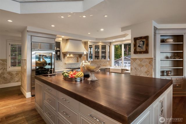 a kitchen with stainless steel appliances granite countertop a sink counter space cabinets and living room view