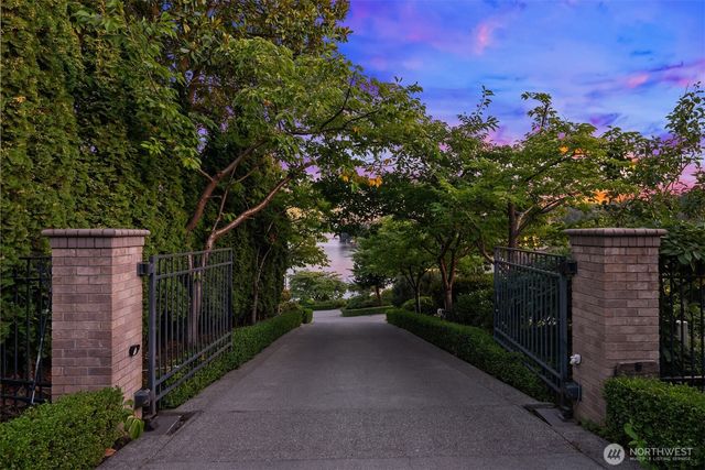 a view of a pathway with a wrought fence