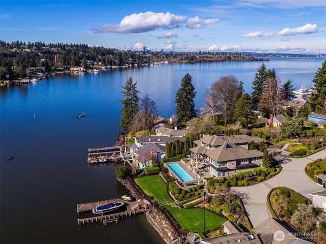 an aerial view of residential house with outdoor space and lake view