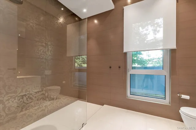 a bathroom with a granite countertop sink a mirror and a shower