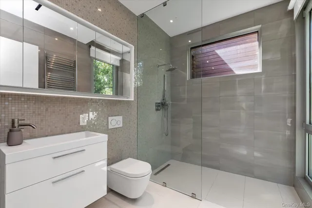 a bathroom with a toilet sink and shower