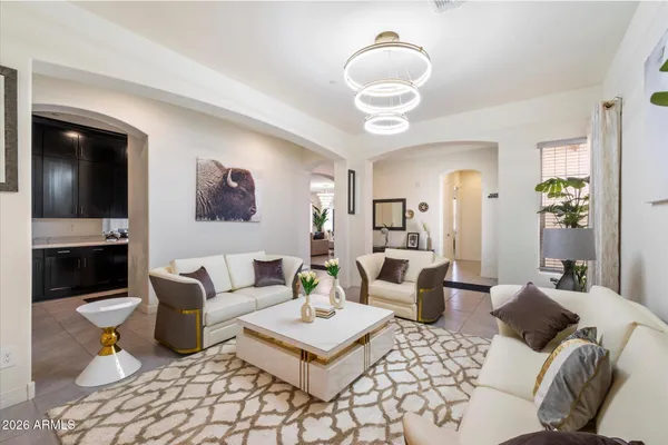 a living room with furniture a rug and a large mirror
