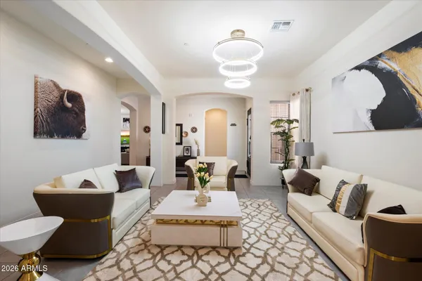 a living room with furniture and a lamp