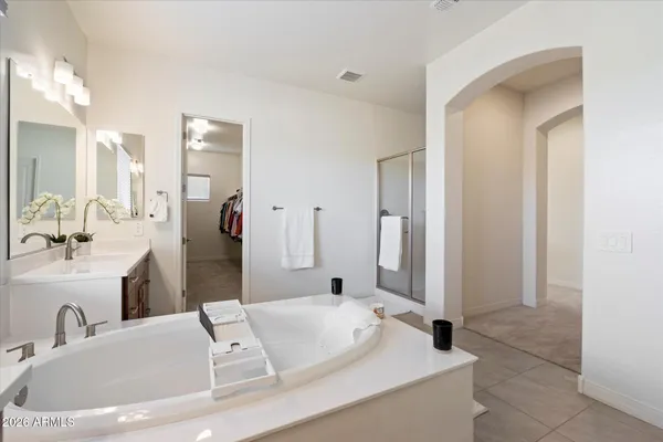 a bathroom with a tub sink and mirror
