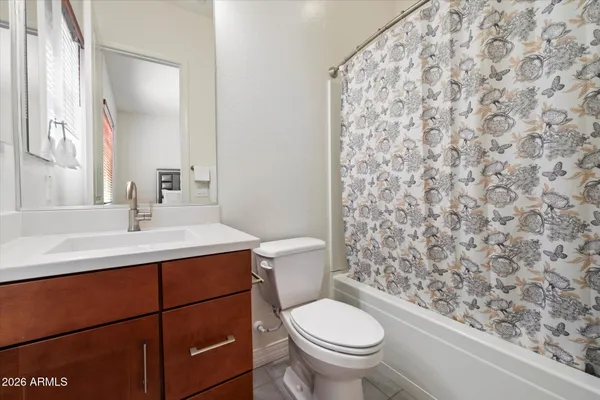 a bathroom with a sink toilet and mirror