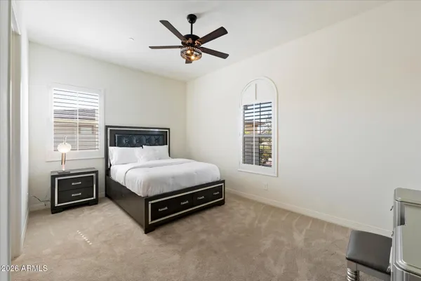 a bedroom with a bed lamp and a window