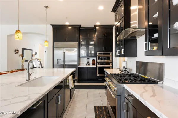 a kitchen with a sink stove and cabinets