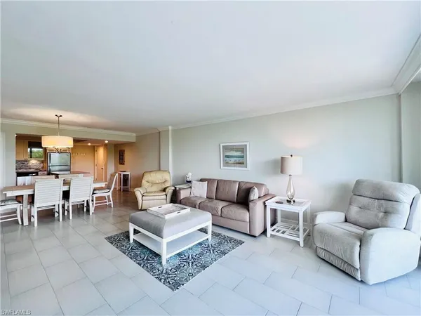 a living room with furniture a lamp and a window