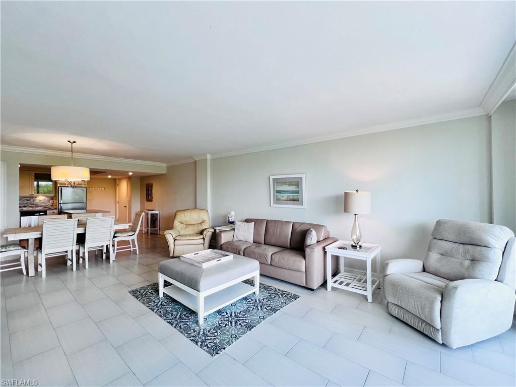 5 Bluebill Avenue, Unit 3031 Naples, FL 34108 - Photo 13 of 24 a living room with furniture a lamp and a window