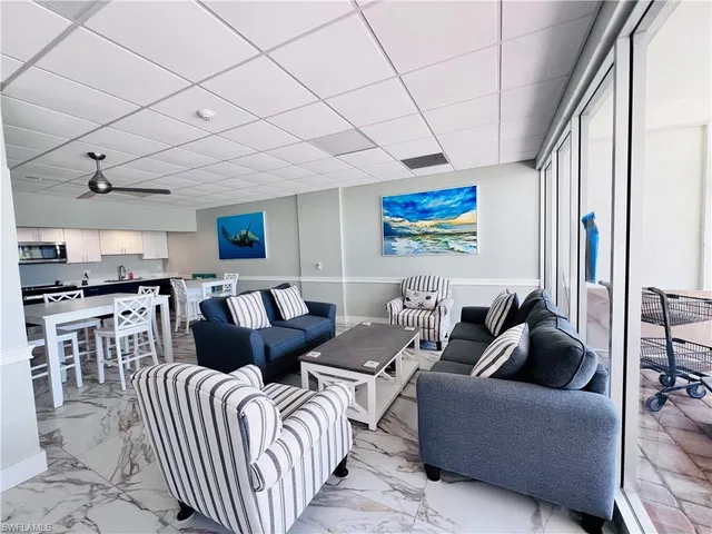 a living room with furniture a rug and white walls