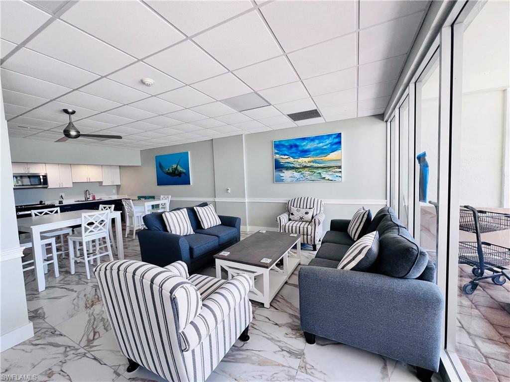 5 Bluebill Avenue, Unit 3031 Naples, FL 34108 - Photo 4 of 24 a living room with furniture a rug and white walls