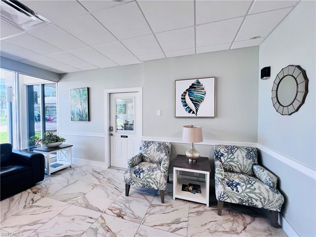 5 Bluebill Avenue, Unit 3031 Naples, FL 34108 - Photo 6 of 24 a living room with furniture and a painting on the wall