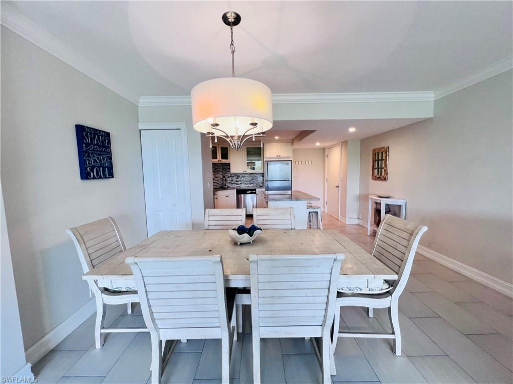 5 Bluebill Avenue, Unit 3031 Naples, FL 34108 - Photo 10 of 24 a view of a dining room with furniture