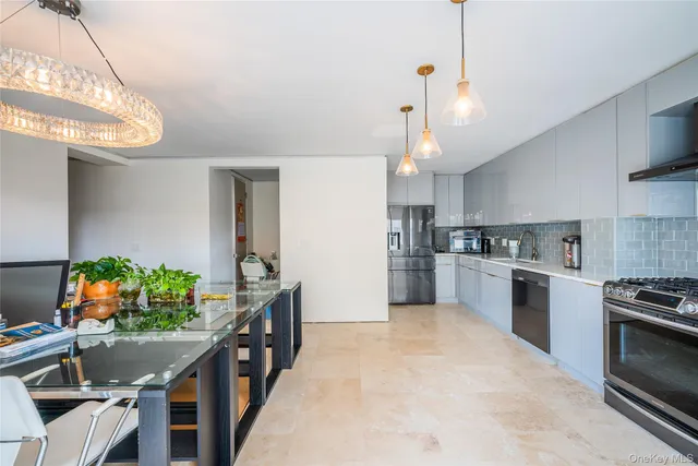 a kitchen with stainless steel appliances granite countertop a stove refrigerator and cabinets