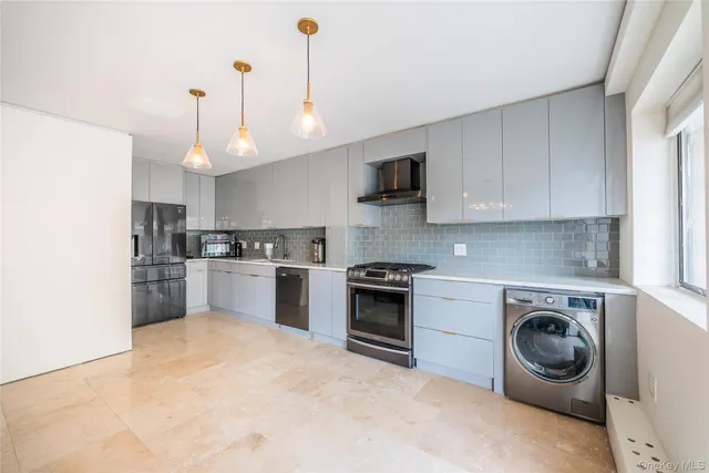 a kitchen with kitchen island a stove a sink and a refrigerator