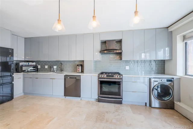 a kitchen with stainless steel appliances granite countertop a stove and a refrigerator