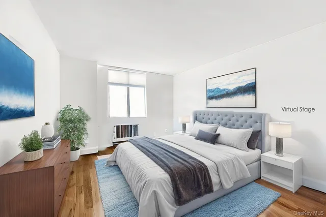 a bedroom with a large bed and a potted plant