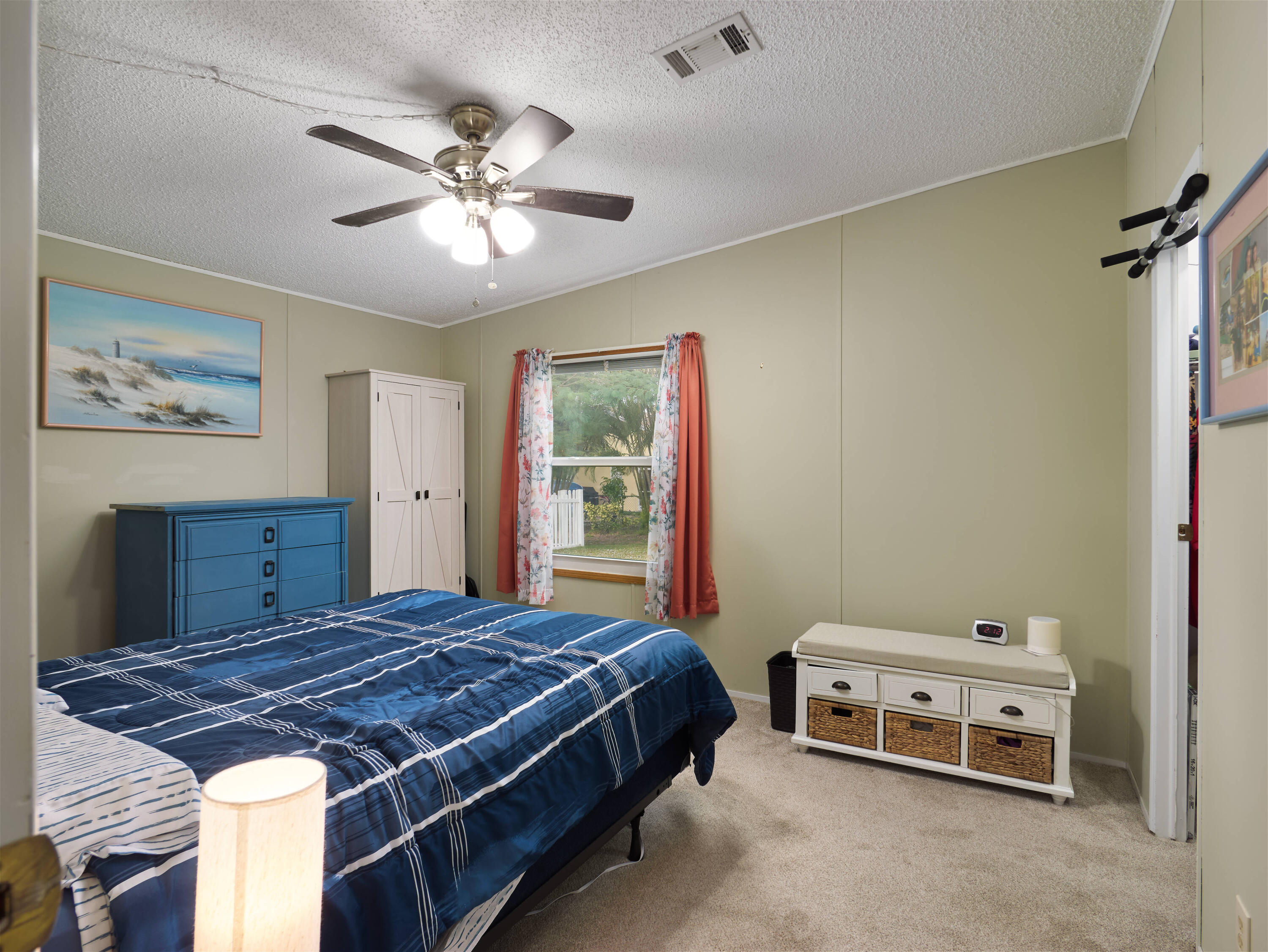 2779 Southwest Olds Place Stuart, FL 34997 - Photo 12 of 41 a bedroom with a bed and a chandelier