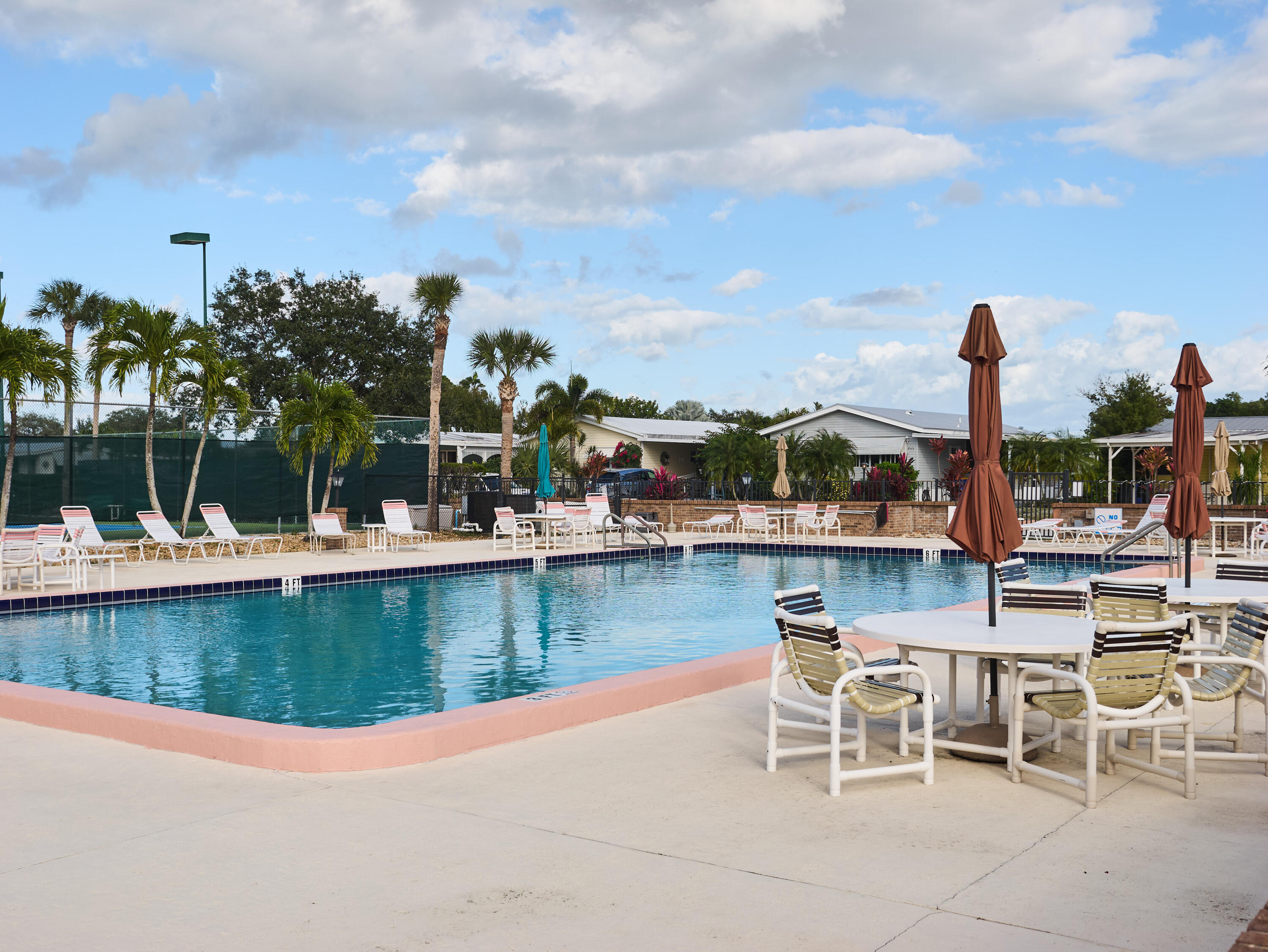 2779 Southwest Olds Place Stuart, FL 34997 - Photo 30 of 41 a view of a swimming pool with outdoor seating