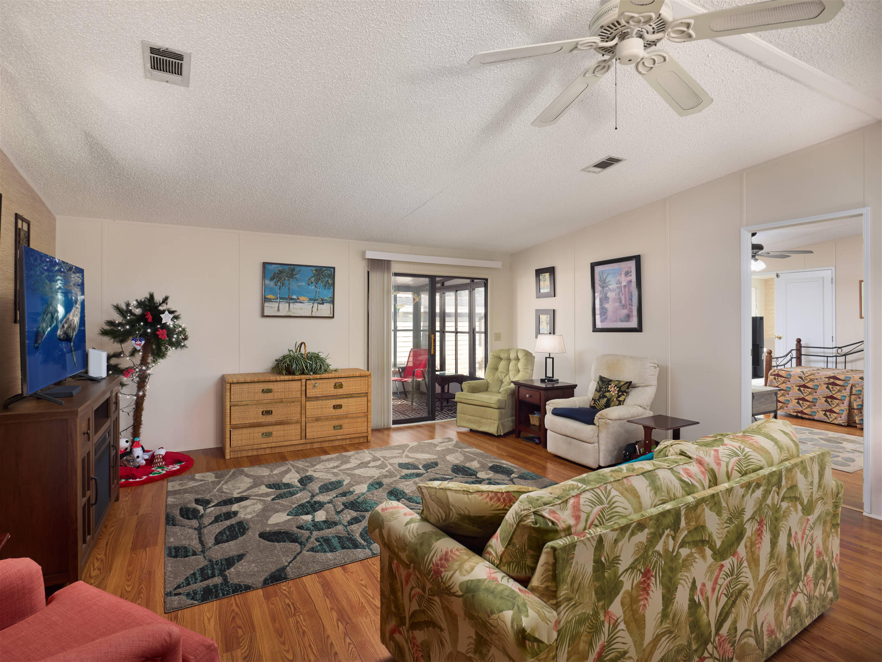 2779 Southwest Olds Place Stuart, FL 34997 - Photo 4 of 41 a living room with furniture and a chandelier