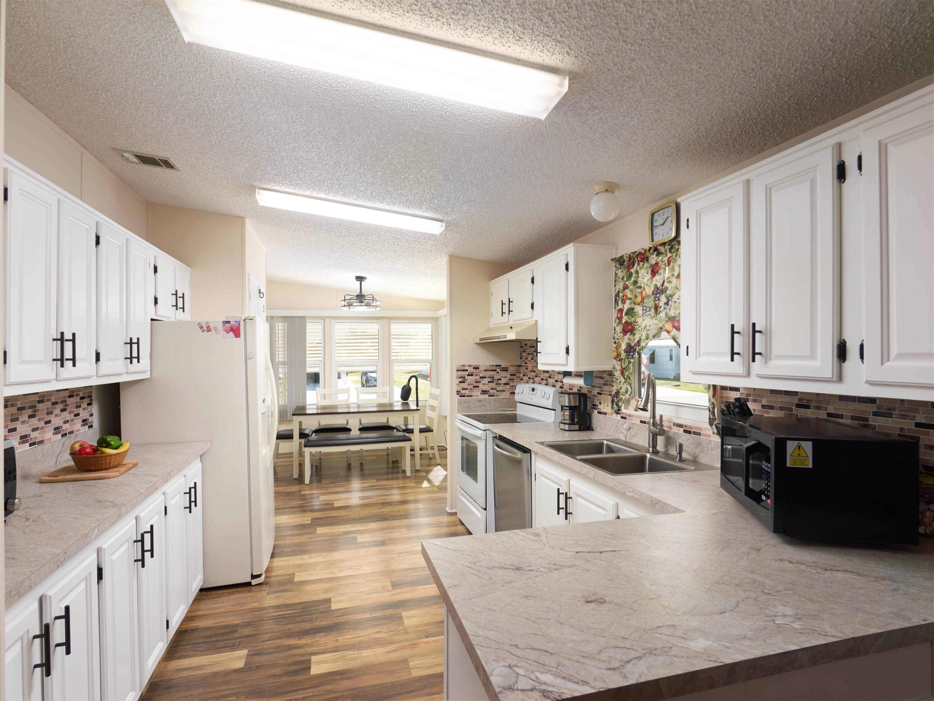 2779 Southwest Olds Place Stuart, FL 34997 - Photo 6 of 41 a kitchen with stainless steel appliances granite countertop a stove oven and a refrigerator