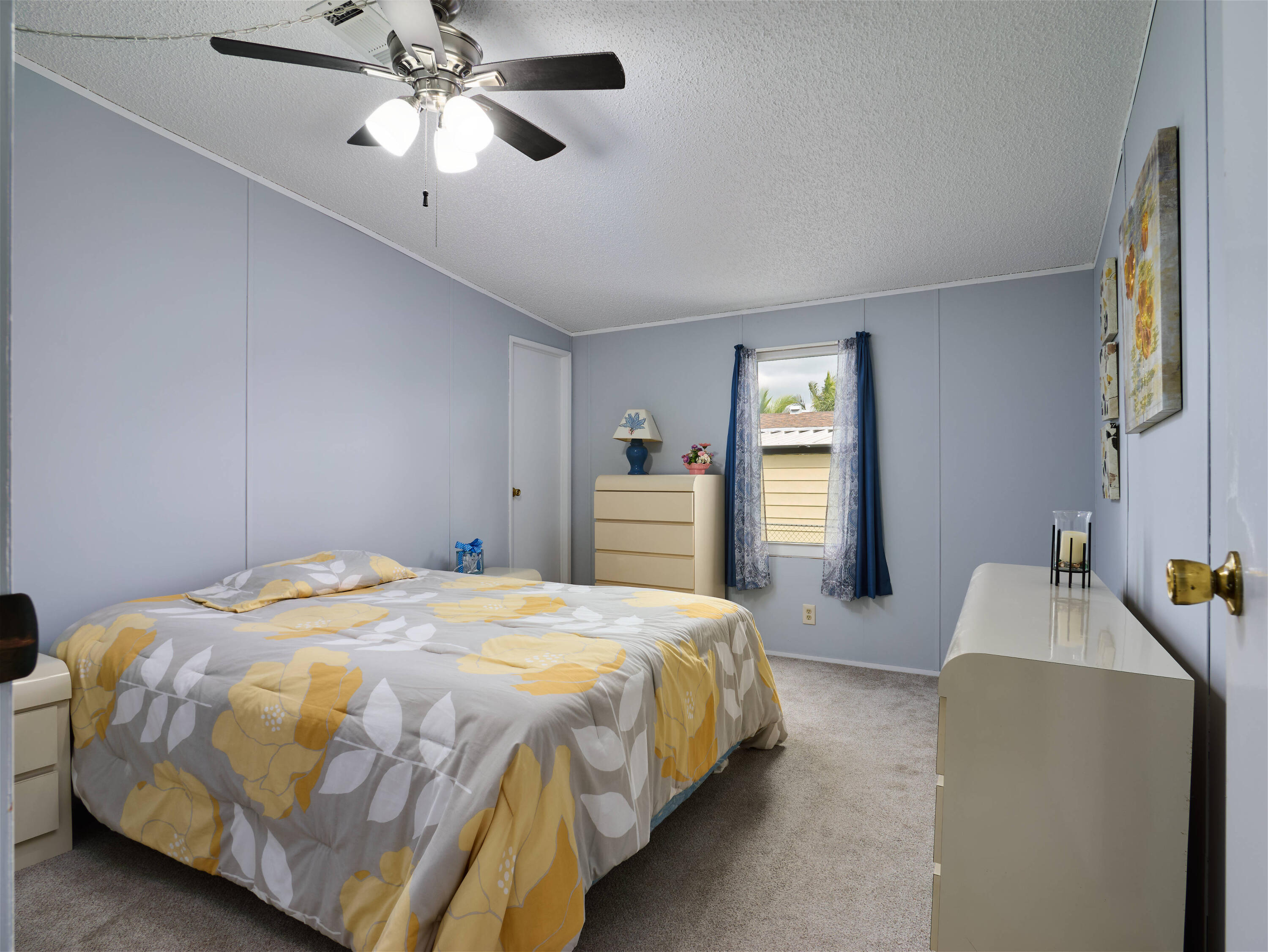 2779 Southwest Olds Place Stuart, FL 34997 - Photo 10 of 41 a bedroom with a bed and a chandelier
