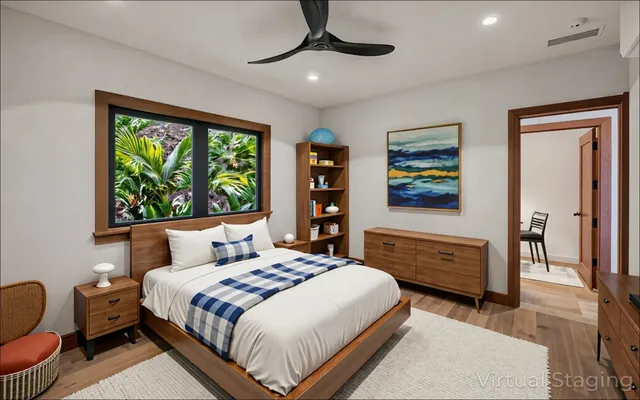 a bedroom with furniture and a large window