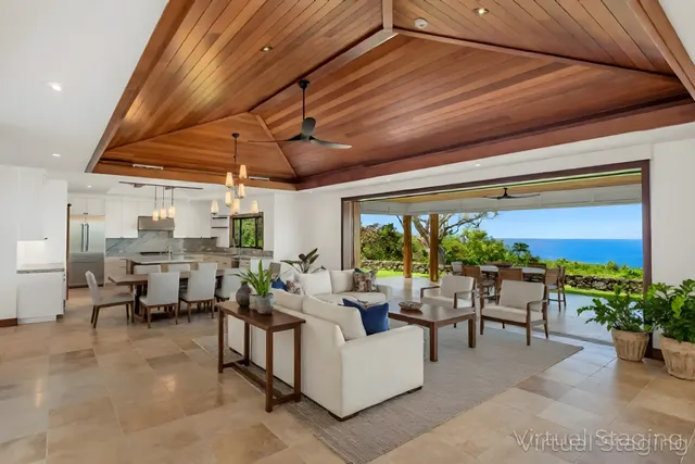 a living room with patio furniture and a potted plant